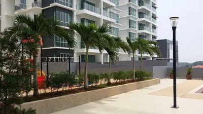 a tall building with palm trees in front of it at Sekinchan 2008 Homestay \u60a6\u5ba2 \u6cd5\u5f0f\u5976\u6cb9\u98ce\u6c11\u5bbf in Sekincan