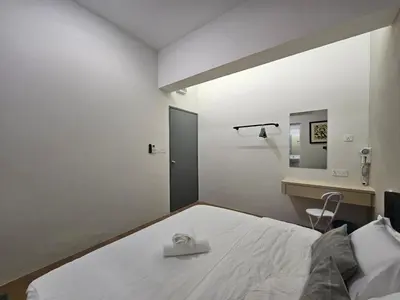 a bedroom with a white bed and a mirror at Summer Home 15 Georgetown Adventist in George Town
