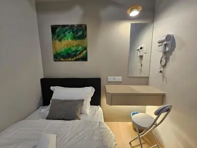a bedroom with a bed and a sink and a mirror at Summer Home 15 Georgetown Adventist in George Town