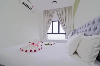 a bedroom with a white bed with white pillows at The Horizon Ipoh L15 by Grab A Stay in Ipoh