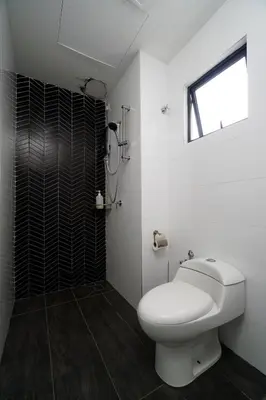 a white bathroom with a toilet and a shower at The Horizon Ipoh L15 by Grab A Stay in Ipoh