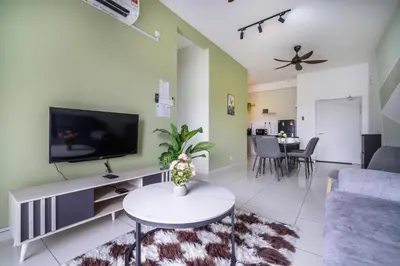 a living room with a tv and a couch at The Horizon Ipoh L15 by Grab A Stay in Ipoh