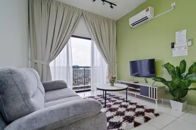 a living room with a couch and a tv at The Horizon Ipoh L15 by Grab A Stay in Ipoh
