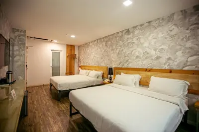 a hotel room with two beds and a wall at Chulia Mansion in George Town