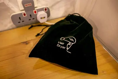 a black bag sitting on the floor next to a camera at Chulia Mansion in George Town