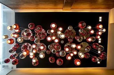 a bunch of wine glasses hanging from a wall at Chulia Mansion in George Town
