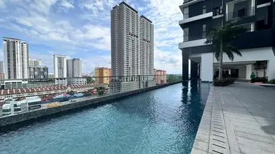 a large swimming pool on the side of a building at Urban Suites in Jelutong
