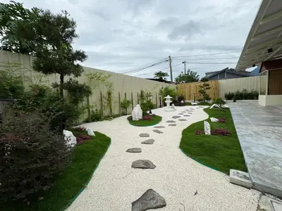 a garden with rocks and a walk way at Muzi Boutique Hotel in Ipoh