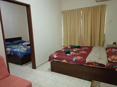 a bedroom with a bed and a mirror at Sofea Inn Bukit Merah - Suria A7245 in Simpang Ampat Semanggol