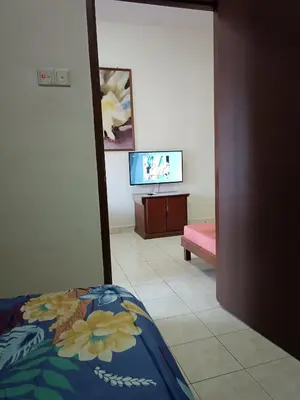 a bedroom with a bed and a tv in a room at Sofea Inn Bukit Merah - Suria A7245 in Simpang Ampat Semanggol