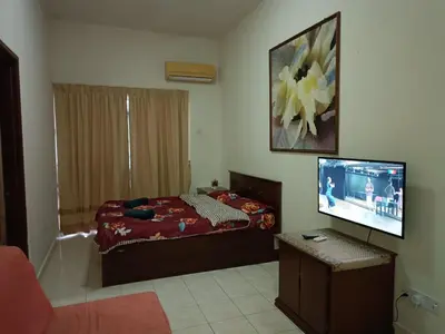 a bedroom with a bed and a flat screen tv at Sofea Inn Bukit Merah - Suria A7245 in Simpang Ampat Semanggol