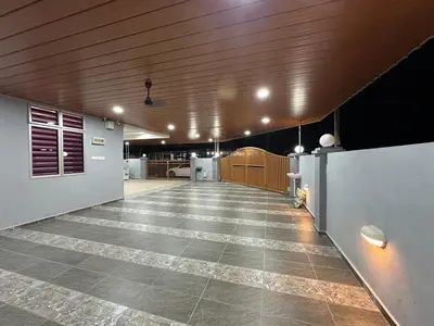 a large room with a tile floor and wooden ceiling at Shan Homestay in Sungai Petani