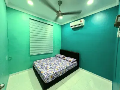 a blue room with a bed and a fan at Shan Homestay in Sungai Petani