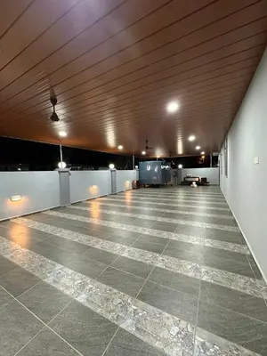 a large empty parking lot with a wooden ceiling at Shan Homestay in Sungai Petani