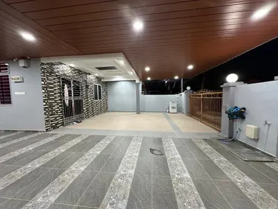 a large empty room with a stone wall at Shan Homestay in Sungai Petani