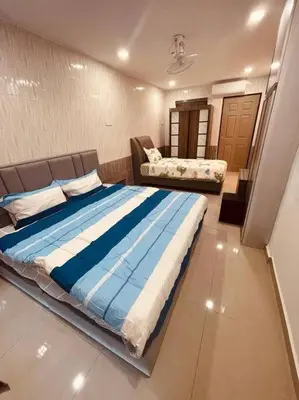 a bedroom with a large bed and a couch at Maxwell Merpati Taiping Homestay in Kamunting