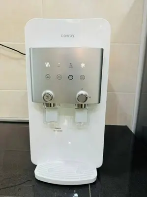 a white controller is sitting on a table at Maxwell Merpati Taiping Homestay in Kamunting