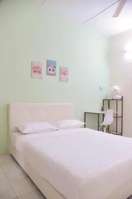 a white bedroom with a white bed and a desk at The Karaoke Homes Ipoh, Oldtown in Ipoh