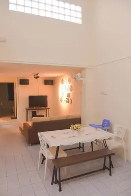 a living room with a table and a couch at The Karaoke Homes Ipoh, Oldtown in Ipoh