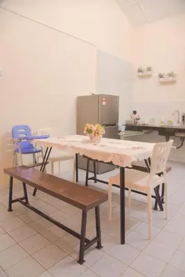 a dining room with a table and chairs in a kitchen at The Karaoke Homes Ipoh, Oldtown in Ipoh