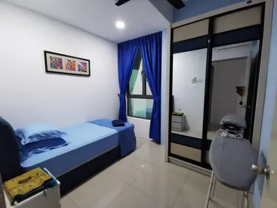a bedroom with a blue bed and a window at Eijaz Homestay @ Casa Kayangan in Ipoh