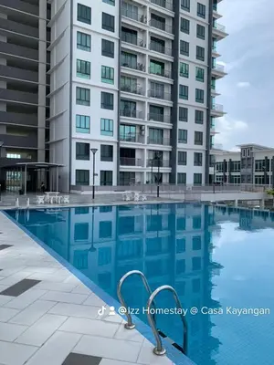 a swimming pool in front of a tall building at Eijaz Homestay @ Casa Kayangan in Ipoh