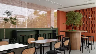 a bar with tables and chairs in a restaurant at La Vie Hotel Juru in Simpang Ampat