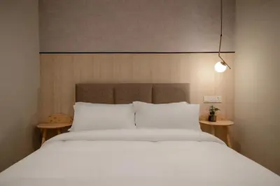 a bedroom with a large bed with white pillows at La Vie Hotel Juru in Simpang Ampat