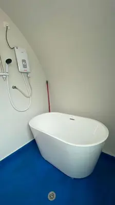 a white sink in a bathroom with a shower at Cameron Highlands Blueberry Earth House in Cameron Highlands