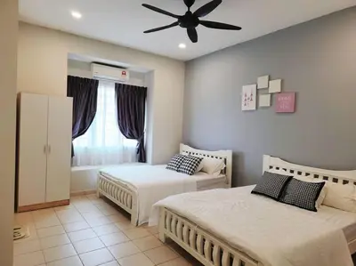 a bedroom with two beds and a ceiling fan at Tmn seri botani ipoh greece 4br 14pax mahjong in Ipoh