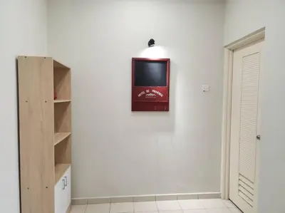 a tv hanging on a wall in a room at Tmn seri botani ipoh greece 4br 14pax mahjong in Ipoh