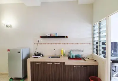 a kitchen with a sink and a refrigerator at Tmn seri botani ipoh greece 4br 14pax mahjong in Ipoh