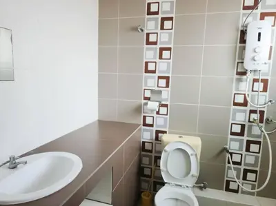 a bathroom with a toilet and a sink at Tmn seri botani ipoh greece 4br 14pax mahjong in Ipoh