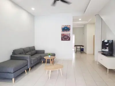 a living room with a couch and a table and a tv at Tmn seri botani ipoh greece 4br 14pax mahjong in Ipoh