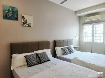 two beds sitting next to each other in a bedroom at Tmn seri botani ipoh greece 4br 14pax mahjong in Ipoh