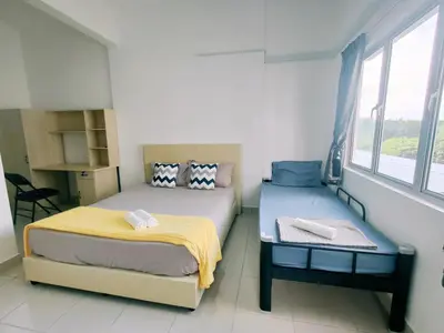 a bedroom with two beds and a window at Cozy Home Kampar (UTAR) 5bedrooms 10pax Free WiFi in Kampar
