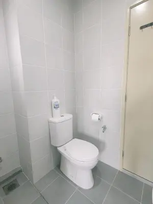 a white bathroom with a toilet and a shower at Cozy Home Kampar (UTAR) 5bedrooms 10pax Free WiFi in Kampar