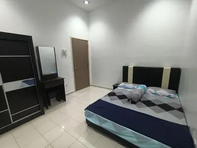 a bedroom with a bed and a dresser and a mirror at HOMESTAY BERTAM SAFAR in Kepala Batas