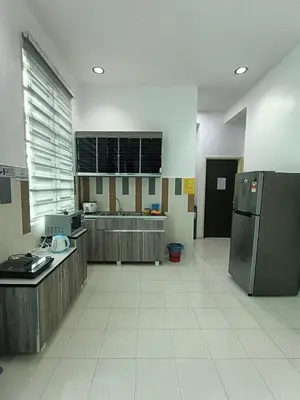 a large kitchen with a refrigerator and a sink at HOMESTAY BERTAM SAFAR in Kepala Batas