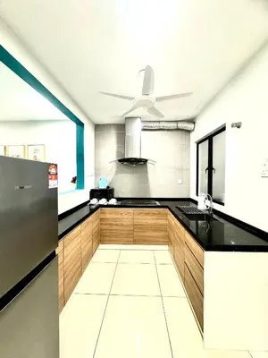 a kitchen with a black counter and a ceiling fan at MyStay IPOH Manhattan waterpark in Ipoh