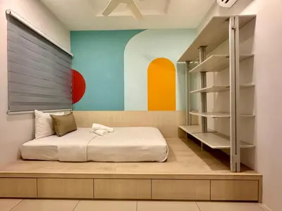 a bedroom with a bed and a shelving unit at MyStay IPOH Manhattan waterpark in Ipoh