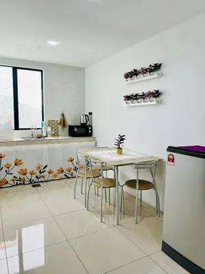 a kitchen with a table and chairs in a kitchen at MyStay IPOH Manhattan waterpark in Ipoh