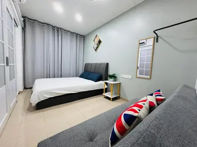 a bedroom with two beds and a couch at Decozy Ten Ipoh Bercham 13 pax Plus in Ipoh