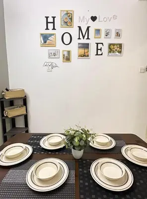 a table with white plates on top of it at Decozy Ten Ipoh Bercham 13 pax Plus in Ipoh