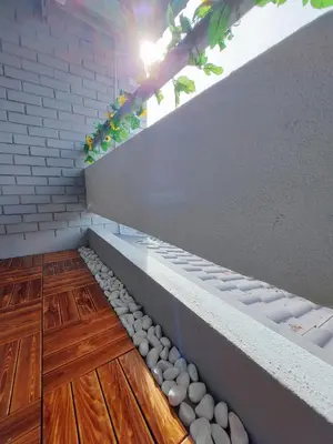 a room with white rocks on the floor and stairs at Decozy Ten Ipoh Bercham 13 pax Plus in Ipoh