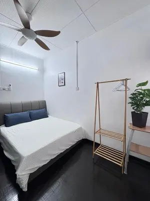 a bedroom with a bed and a ceiling fan at Decozy Ten Ipoh Bercham 13 pax Plus in Ipoh