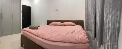 a bedroom with a pink bed with two pillows at Modern 3 bedrooms House, Walking distance to Kulim Town by Mr Homestay in Kulim