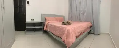 a bedroom with a bed with a pink comforter at Modern 3 bedrooms House, Walking distance to Kulim Town by Mr Homestay in Kulim