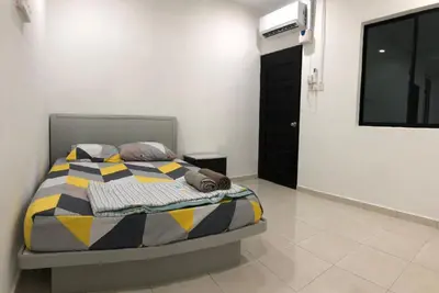 a bedroom with a bed with a colorful comforter at 4 Bedrooms Semi D Homestay by Mr Homestay in Kulim