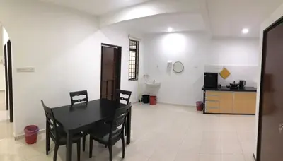 a dining room with a black table and chairs at 4 Bedrooms Semi D Homestay by Mr Homestay in Kulim